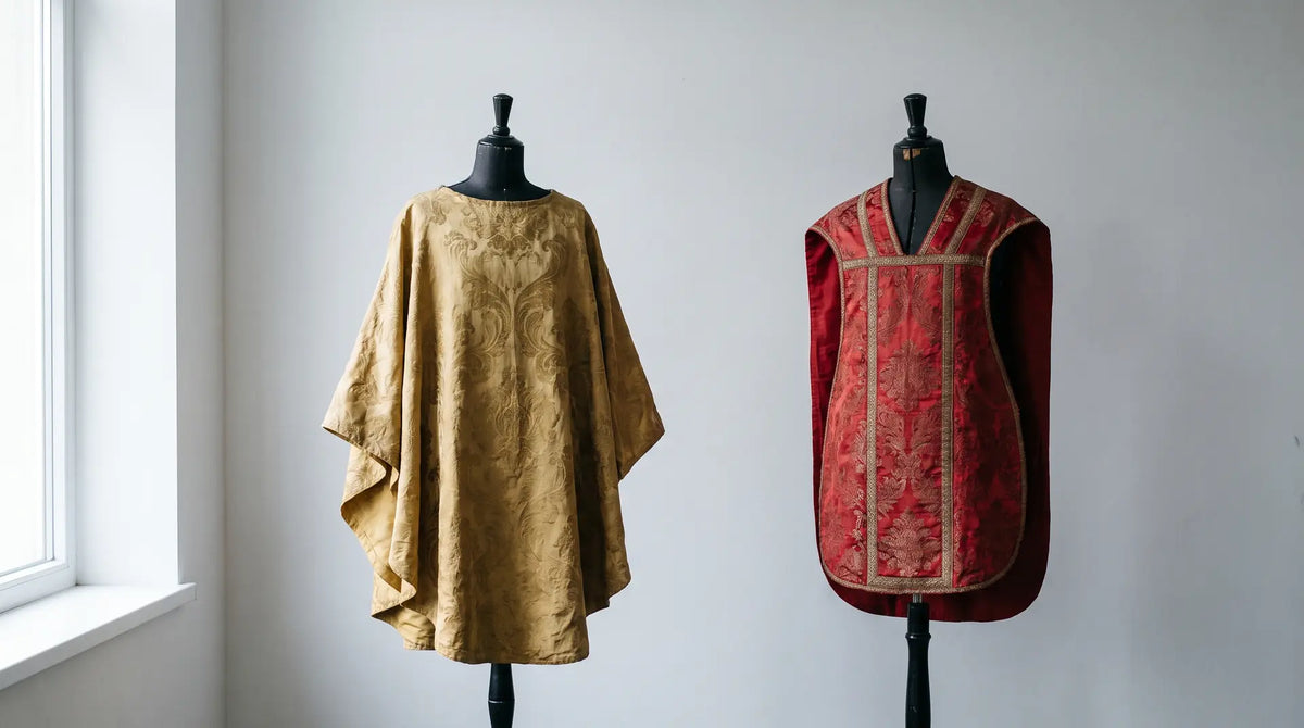 An ample gothic chasuble in gold damask beside a narrow Roman fiddleback chasuble in red brocade on dress forms