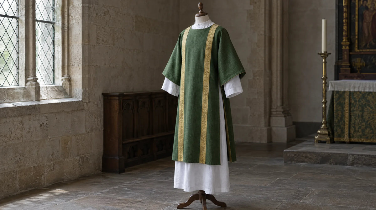 Green dalmatic with two gold vertical bands worn over a white alb on a dress form, showing the wide sleeves and open sides