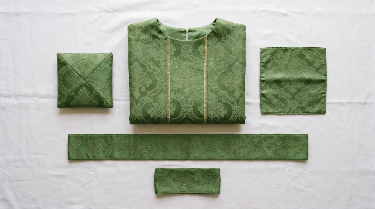 A green damask low Mass set laid out showing chasuble, stole, maniple, burse and chalice veil