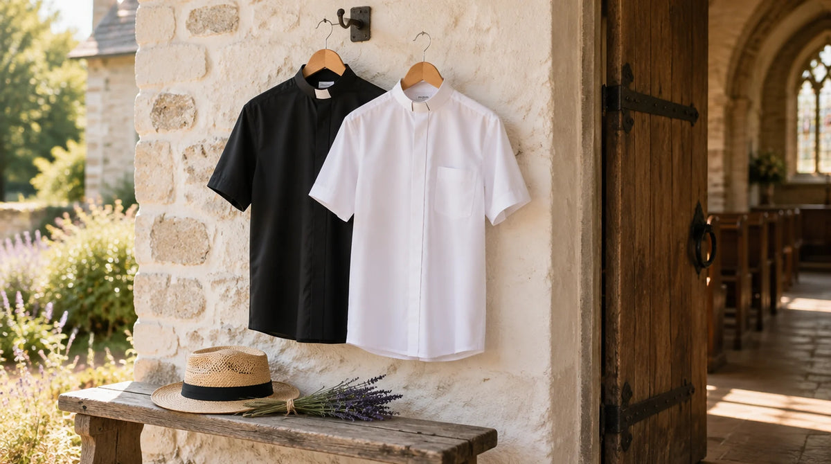 A black and a white short-sleeve tab-collar clergy shirt on hangers by a sunlit church porch door