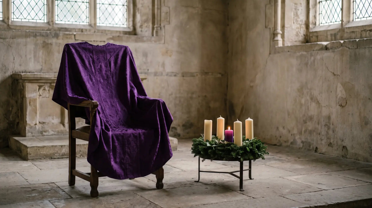 A deep violet chasuble laid over a sanctuary chair beside an Advent wreath with one candle lit