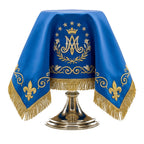 The Marian blue chalice veil draped over a chalice, with the crowned Ave Maria monogram to the front.