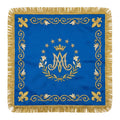 Marian blue chalice veil laid flat, showing the crowned Ave Maria monogram in a wreath of lilies with fleur-de-lis at the corners.