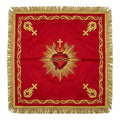 Red Sacred Heart chalice veil laid flat, showing the crimson and gold heart crowned with thorns and set in rays, with gold emblems at the corners.