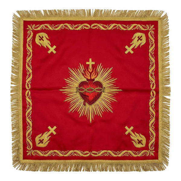 Red Sacred Heart chalice veil laid flat, showing the crimson and gold heart crowned with thorns and set in rays, with gold emblems at the corners.
