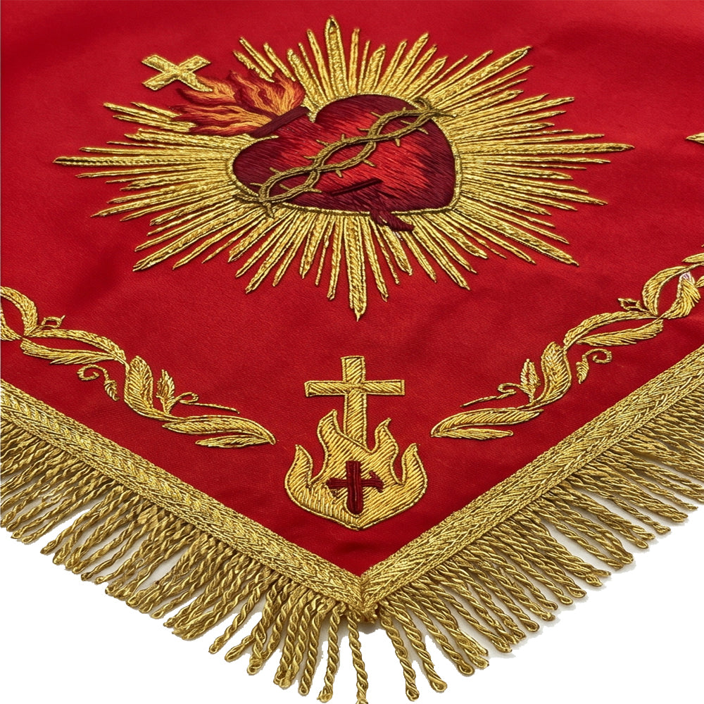 Close-up of the Sacred Heart embroidery, showing the crown of thorns, flames and raised gold rays on red satin.