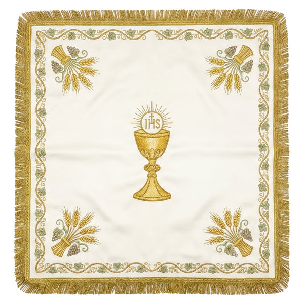 Ivory-white chalice veil laid flat, showing the gold chalice beneath the IHS host, wheat sheaves at the corners and a gold border.