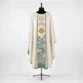 Front of an ivory baptism chasuble with a full-length orphrey embroidered with the Holy Spirit dove in gold rays, a gold scallop shell and the Jordan river in aqua and silver