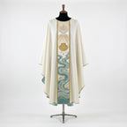 Front of an ivory baptism chasuble with a full-length orphrey embroidered with the Holy Spirit dove in gold rays, a gold scallop shell and the Jordan river in aqua and silver
