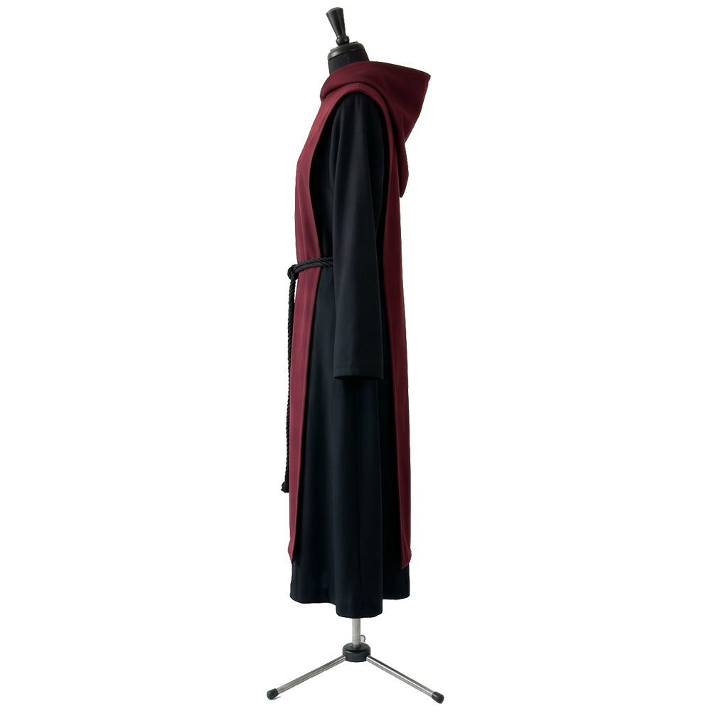 Side profile of a black and burgundy monk habit showing the standing hood and bell sleeve.