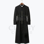 Front view of a black clergy cassock robe on a hanger, showing the stand collar and the wide sash belt with hanging tassel.