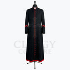 Front view of a black clergy cassock robe with a full-length red button placket and red piping at the collar.