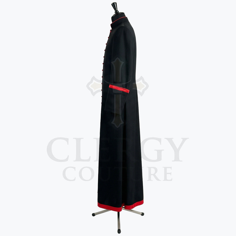 Side view of the black cassock robe showing the red cuff band and the red band at the hem.