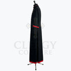 Side view of the black cassock robe showing the red cuff band and the red band at the hem.