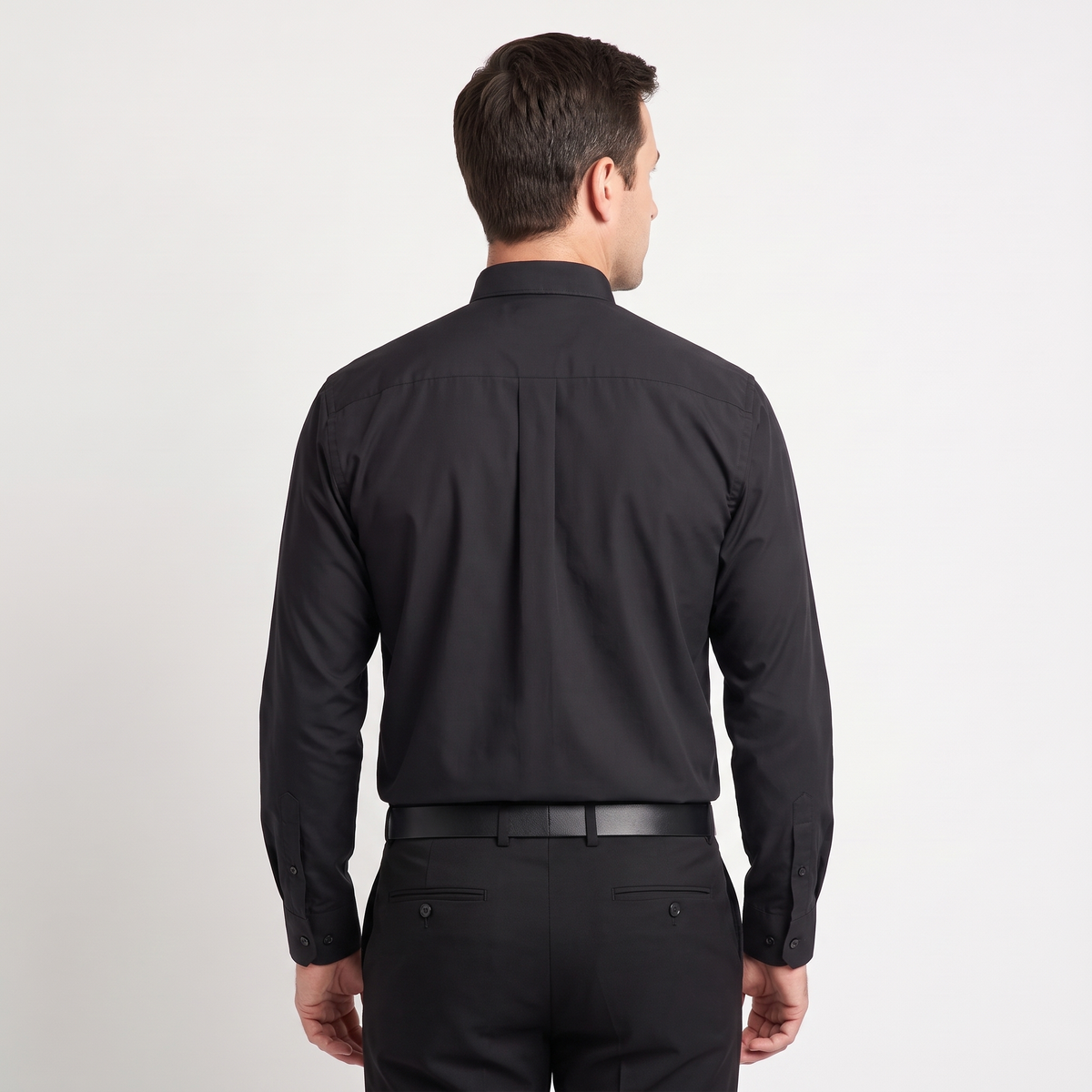 Back view of the black clergy shirt showing the shoulder yoke and centre pleat.