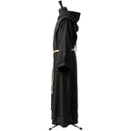 Side profile of a black hooded habit showing the cuffed sleeve and knotted tan rope cincture tassels.