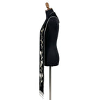 Close side view of the black calla lily stole showing the vine, blooms and silver beaded fringe in detail