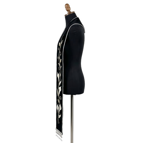 Close side view of the black calla lily stole showing the vine, blooms and silver beaded fringe in detail