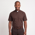The short-sleeve version of the brown tab-collar clergy shirt, worn with dark trousers.