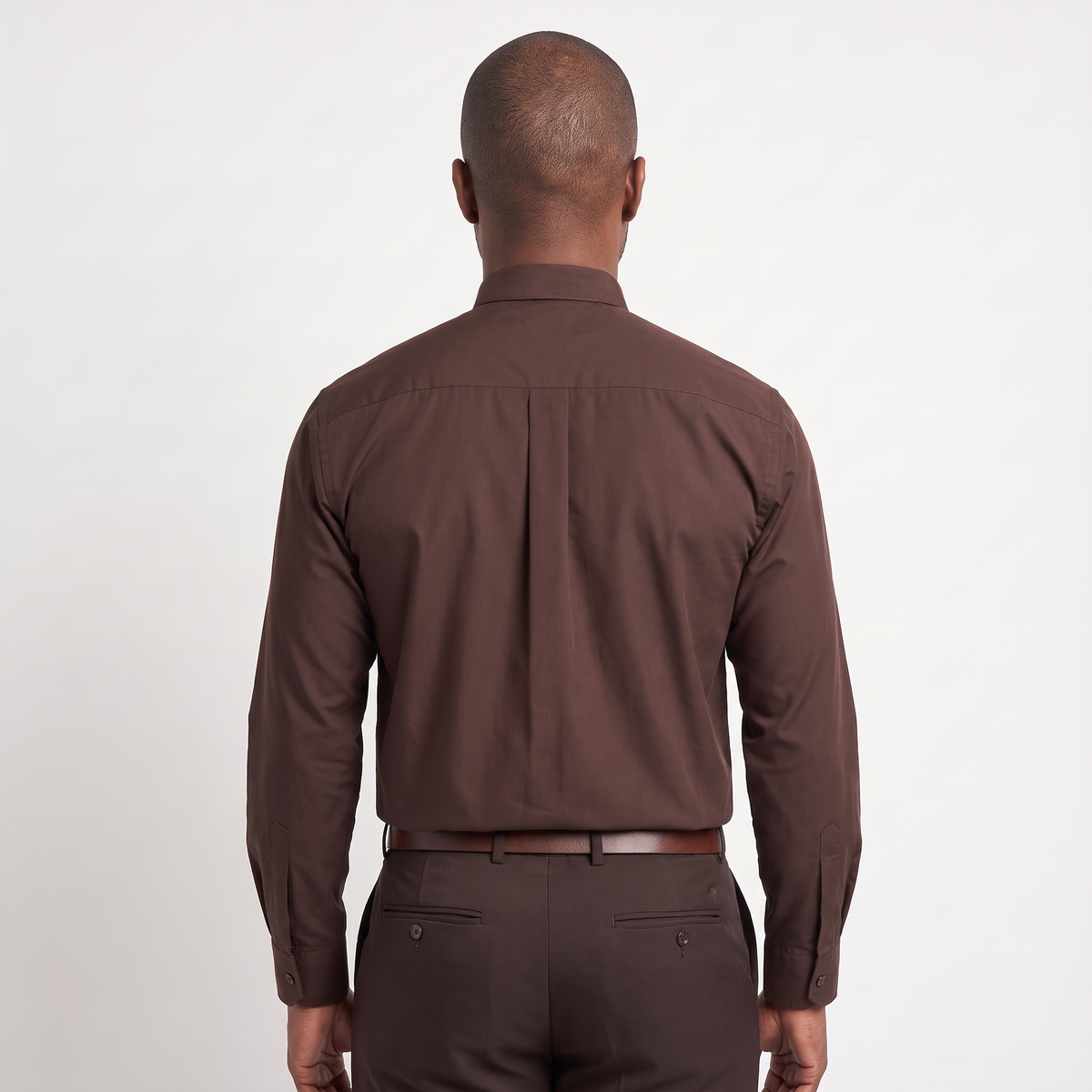 Back view of the brown clergy shirt showing the shoulder yoke and centre pleat.