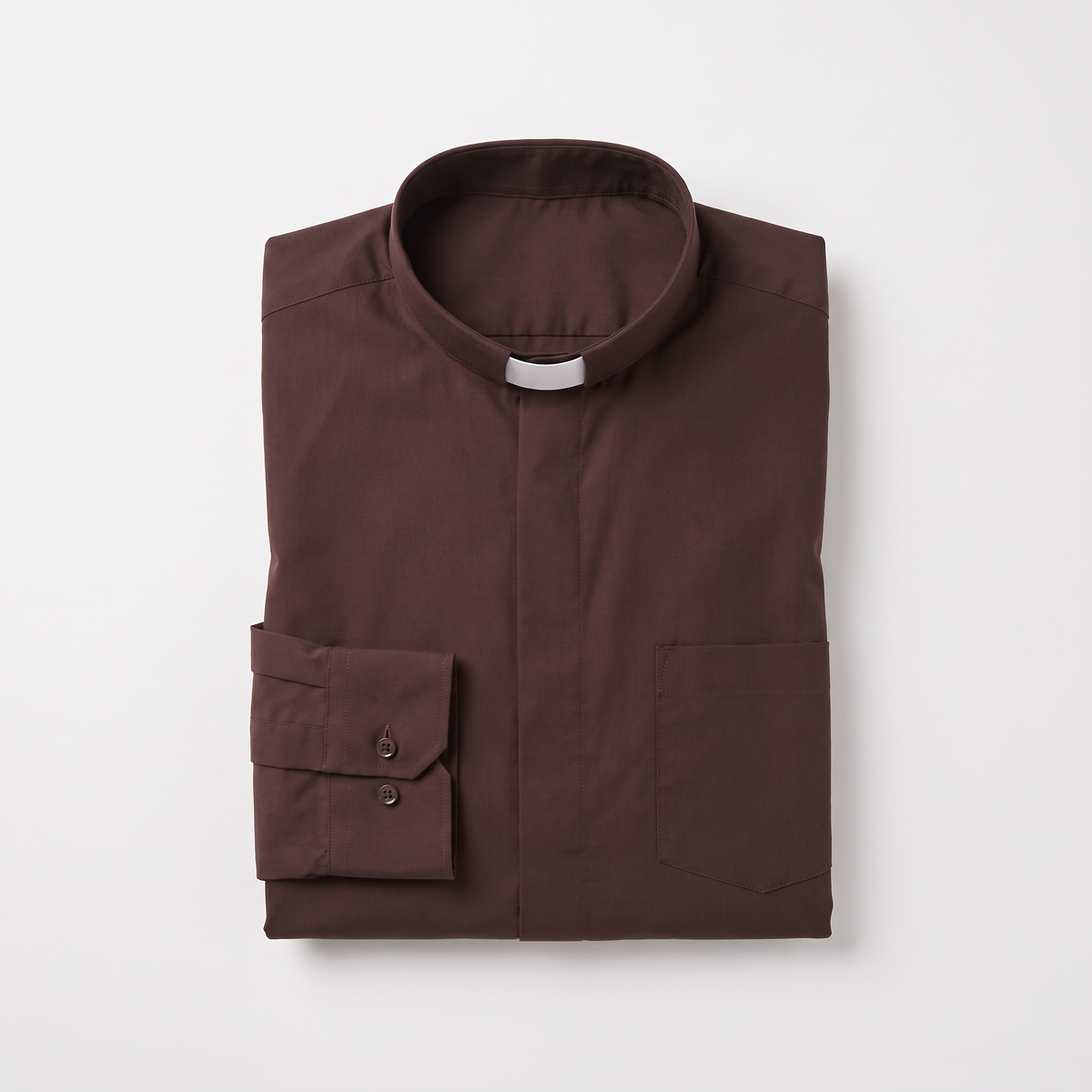 The brown long-sleeve clergy shirt folded, with the collar standing and a buttoned barrel cuff visible.