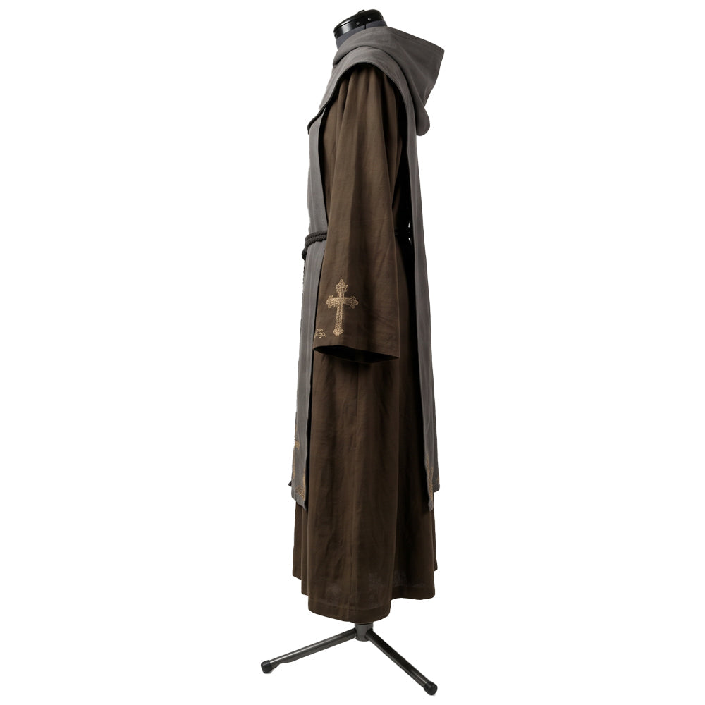 Side profile of a brown monk habit showing the gold cross motif embroidered on the sleeve cuff.