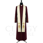 Front view of a burgundy clergy cassock robe worn with the optional cream stole embroidered with a gold chalice and cross.
