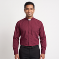 Man wearing the burgundy long-sleeve tab-collar clergy shirt with a white tab (shown for styling, not included), covered placket and left chest pocket, against a light grey background.