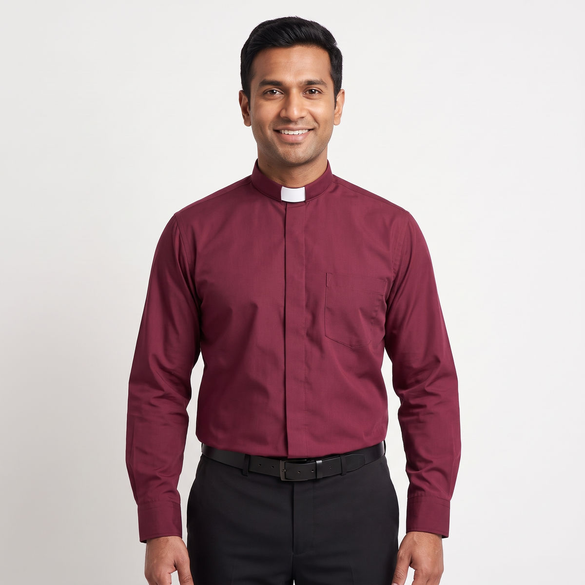 Man wearing the burgundy long-sleeve tab-collar clergy shirt with a white tab (shown for styling, not included), covered placket and left chest pocket, against a light grey background.