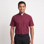 The short-sleeve version of the burgundy tab-collar clergy shirt, worn with dark trousers.