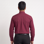 Back view of the burgundy clergy shirt showing the shoulder yoke and centre pleat.