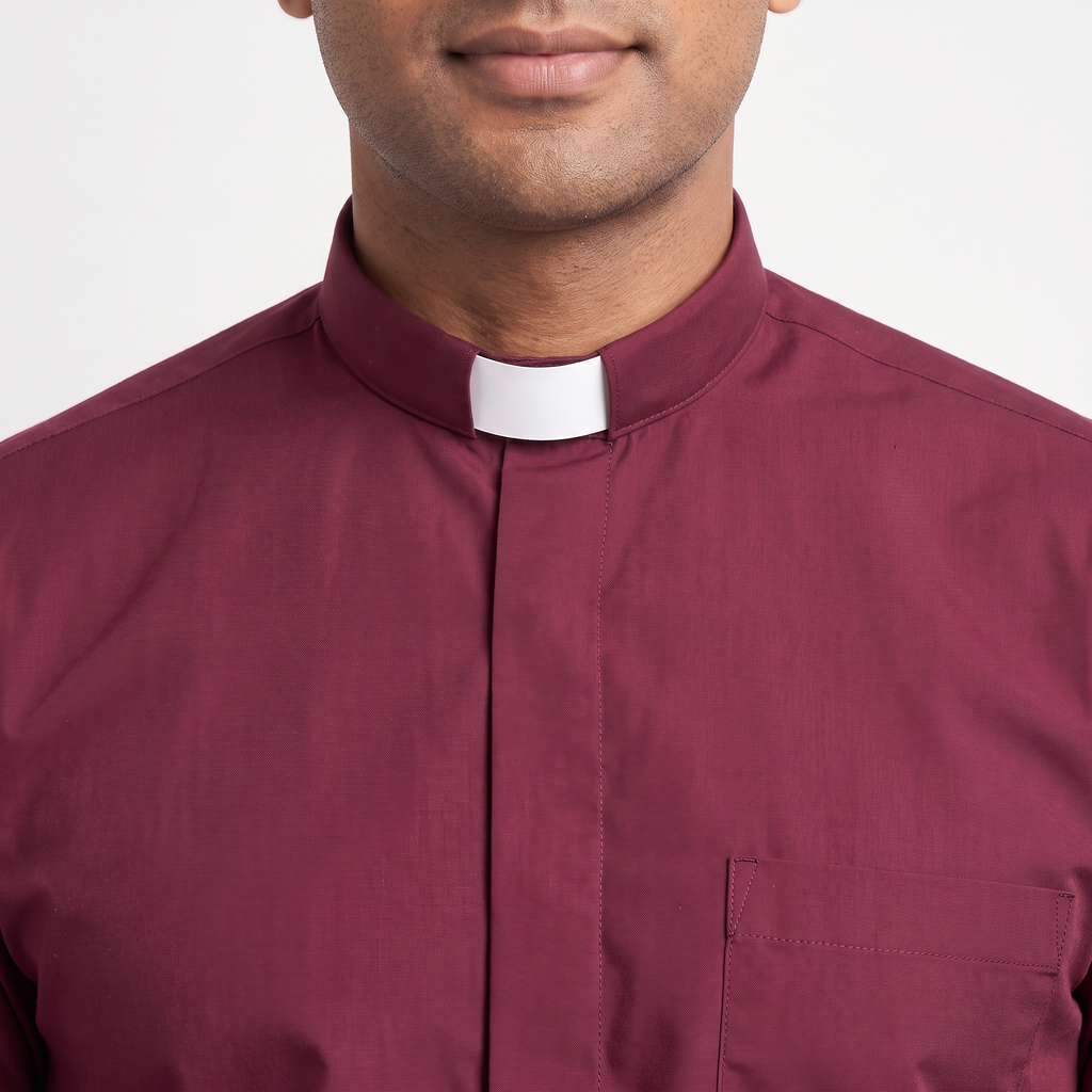 Close-up of the tall burgundy tab collar with a white tab, the covered button placket and the top of the chest pocket.