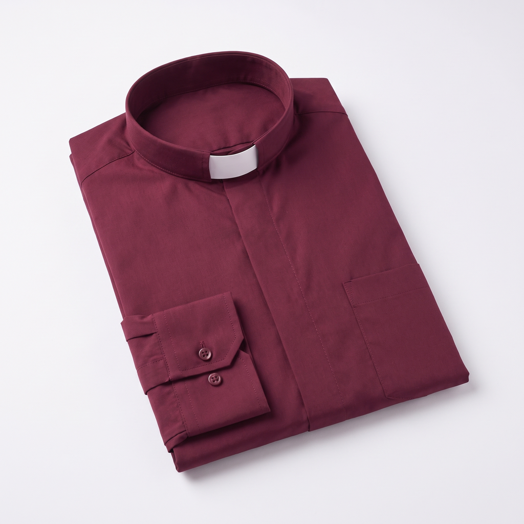The burgundy long-sleeve clergy shirt folded, with the collar standing and a buttoned barrel cuff visible.