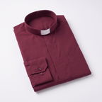 The burgundy long-sleeve clergy shirt folded, with the collar standing and a buttoned barrel cuff visible.
