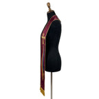 Side view of the burgundy affirming ministry stole on a dress form, showing the gold cross and its rainbow ribbon.