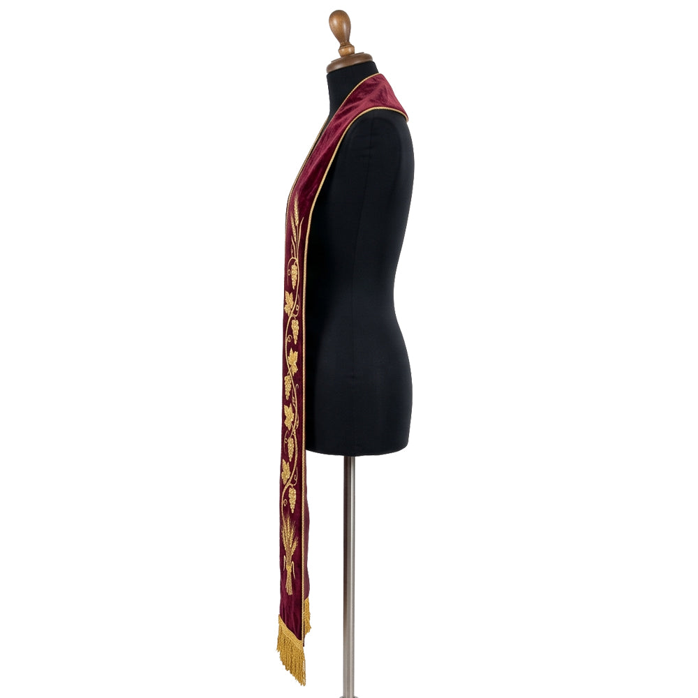 Close side view of the burgundy velvet-look stole's gold grape clusters, vine leaves and wheat sheaf embroidery
