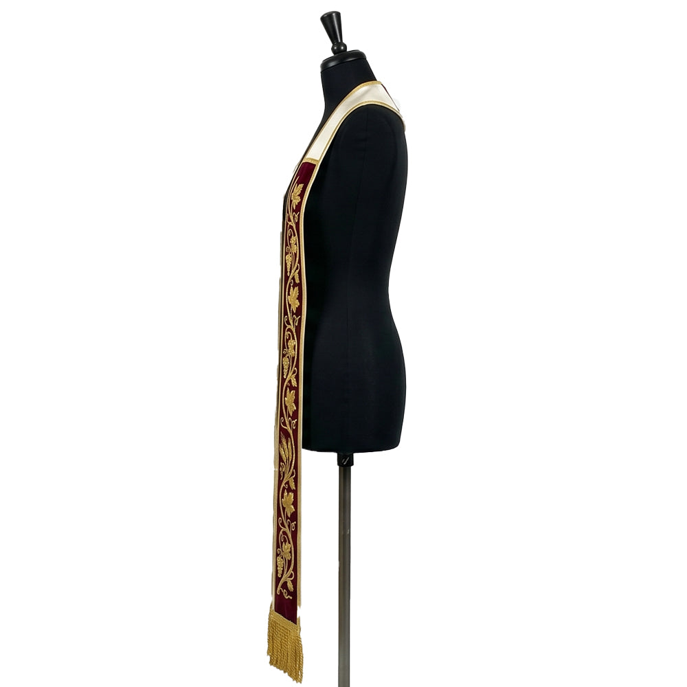 Side profile of the burgundy velvet-look Grapevine and Wheat Stole showing gold bullion fringe at the hem