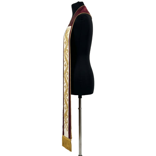 Close side view of the burgundy and ivory stole's gold wheat, ribbon and small cross embroidery in detail