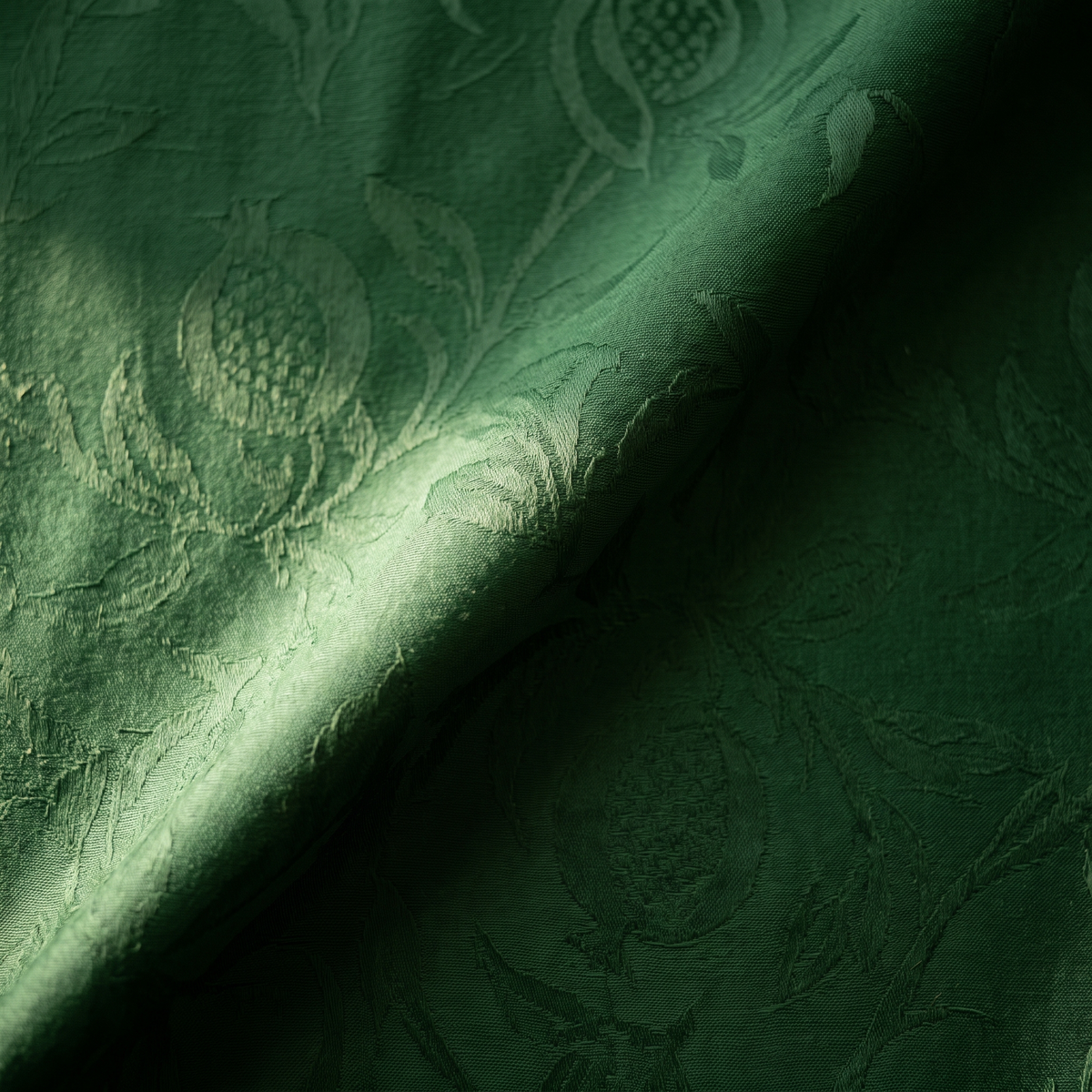 Deep green damask, the pattern woven tone on tone and visible only in raking light