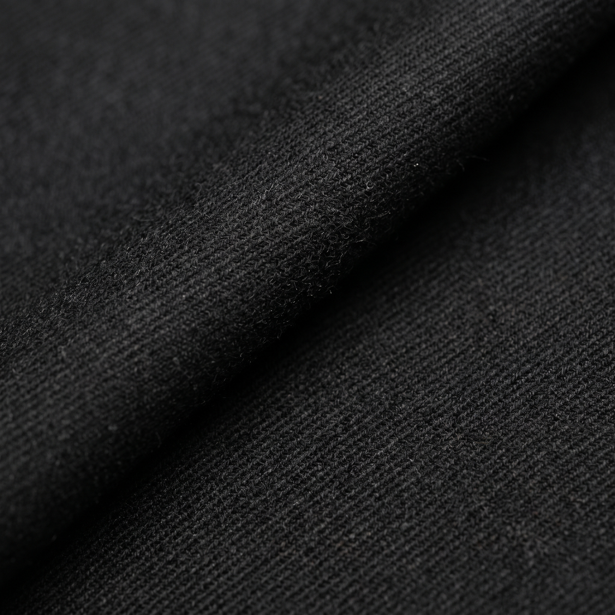 Fine black worsted wool suiting with a tight twill weave and a pressed fold
