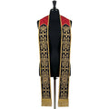 Roman-style priest stole on a mannequin, red yoke and navy velvet-look bands with gold scrollwork and crosses.