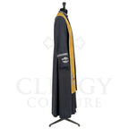 Side view of the charcoal cassock robe showing the gold yoke and the hip pocket marked with a silver fish.