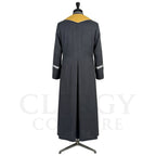 Back view of the charcoal cassock robe without the stole, showing the pointed gold yoke and the silver cuff bands.
