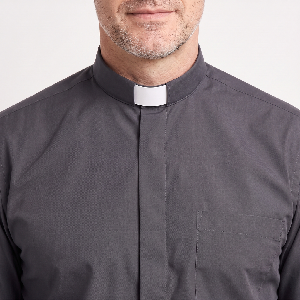 Close-up of the tall charcoal tab collar with a white tab, the covered button placket and the top of the chest pocket.