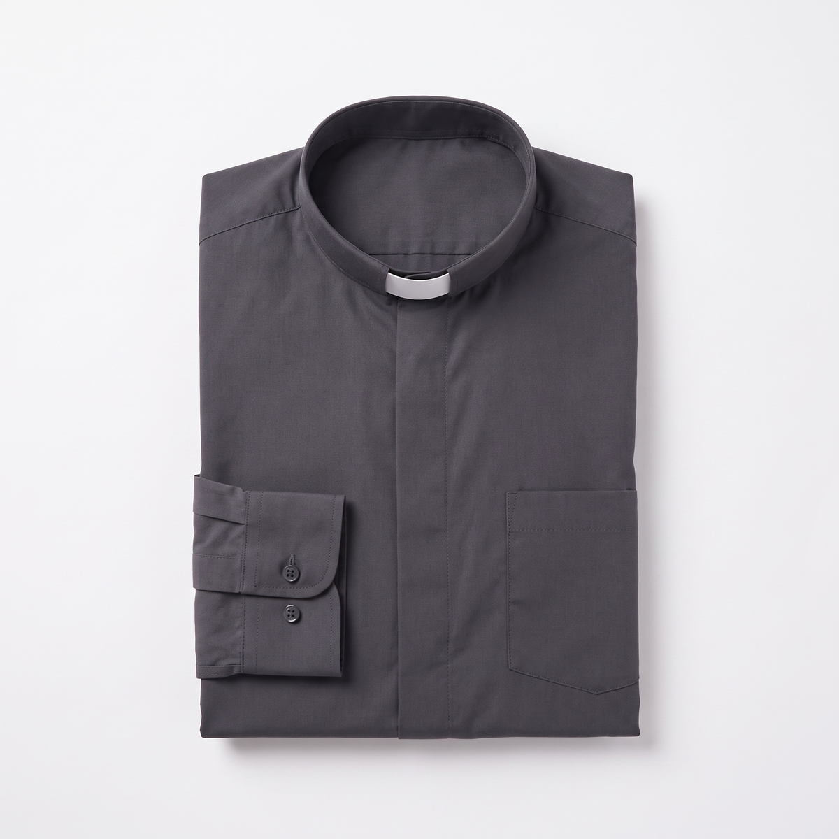 The charcoal long-sleeve clergy shirt folded, with the collar standing and a buttoned barrel cuff visible.