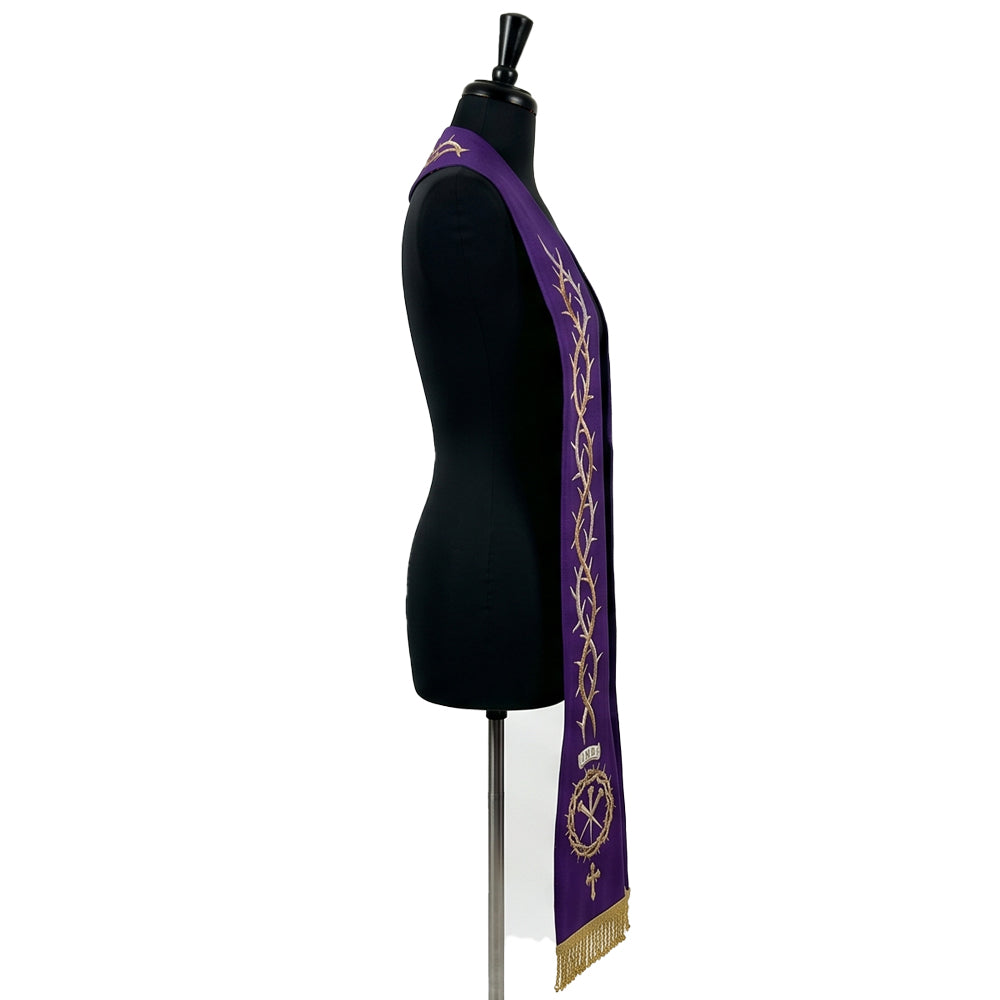 Side view of the crown-of-thorns Lent stole on a dress form, showing the INRI banner and cross above gold beaded fringe.