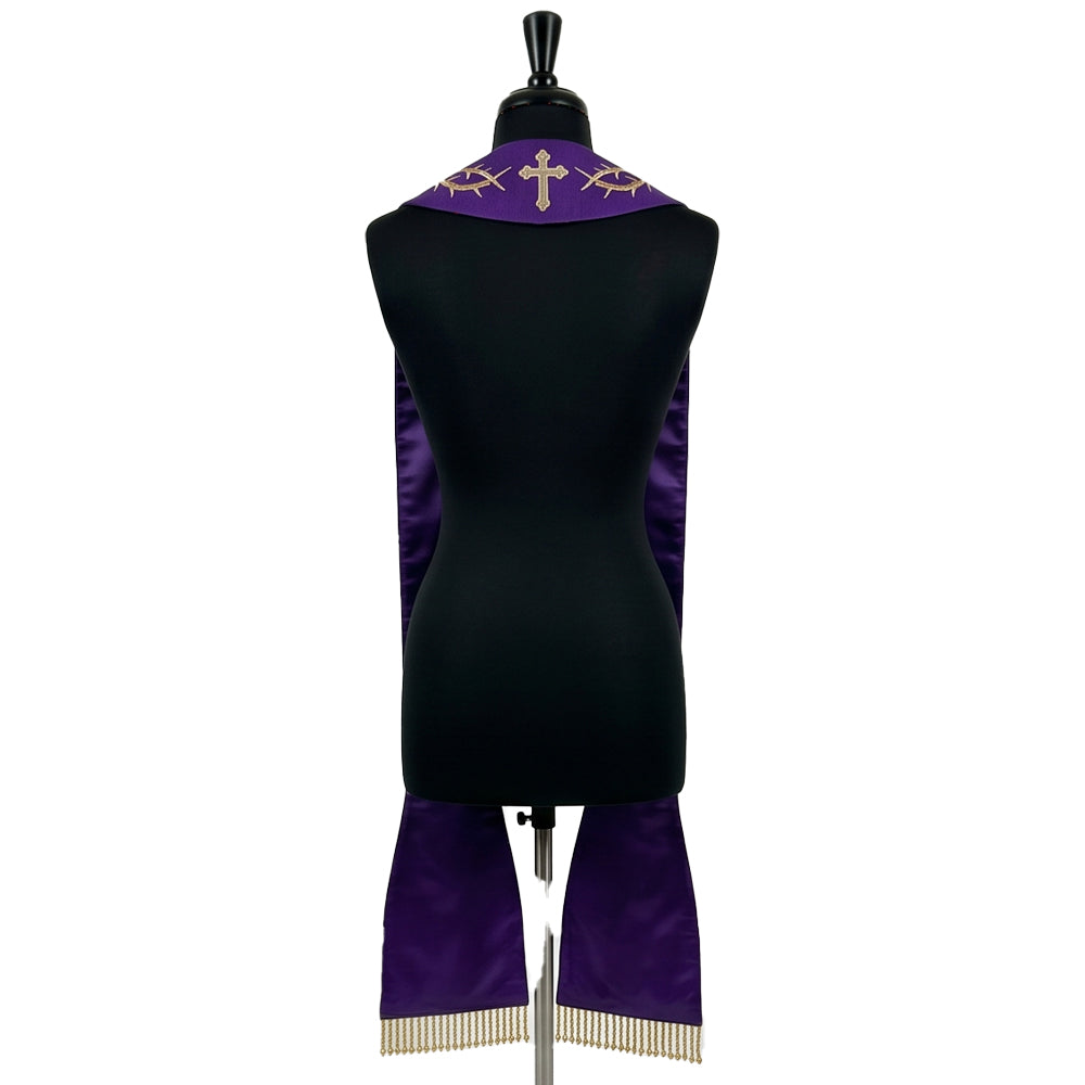 Back view of the violet Lent stole on a dress form, with a small cross and thorn sprigs embroidered at the collar.