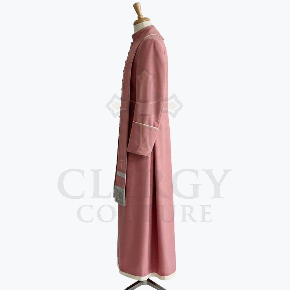 Side view of the dusty rose cassock robe showing the cream hem band and the silver fringe at the chest.