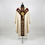 Back of the Epiphany chasuble with a Y-shaped burgundy velvet orphrey: three gold crowns, a large comet star and roundels holding a chest, a censer and a jar
