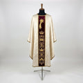Front of an ivory damask Epiphany chasuble with a burgundy velvet column orphrey embroidered in gold with a comet star, a crown and roundels of the Magi's gifts